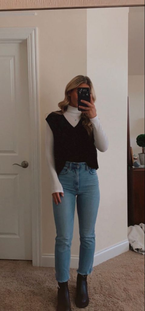 White turtleneck sweater vest jeans and ankle boots